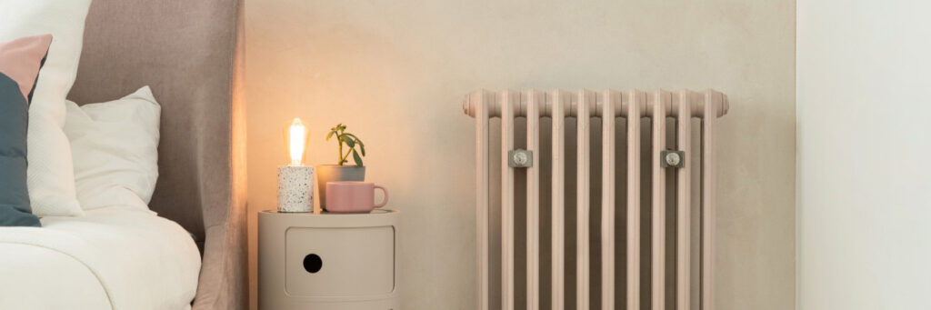 Custom made cast iron radiator under window in bathroom