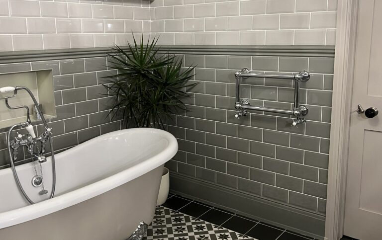 Lifestyle photo of Elara towel rail in stylish tiled bathroom. 