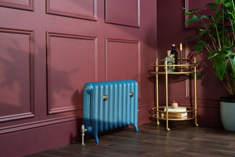 Lifestyle photo of Castrads Emmeline custom made cast iron radiator for steam and hot water heating in Paint & Paper Library's 'Mockingbird'.