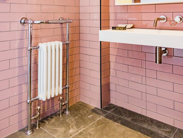 Lifestyle image of traditional style Vivien bathroom radiator with towel bar.