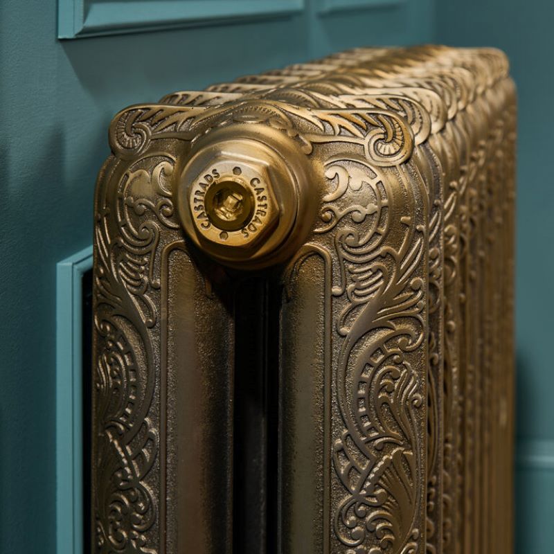 Ornate cast iron radiator in hand polished aged gold finish